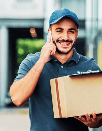 Courier delivery man carrying a box for delivery