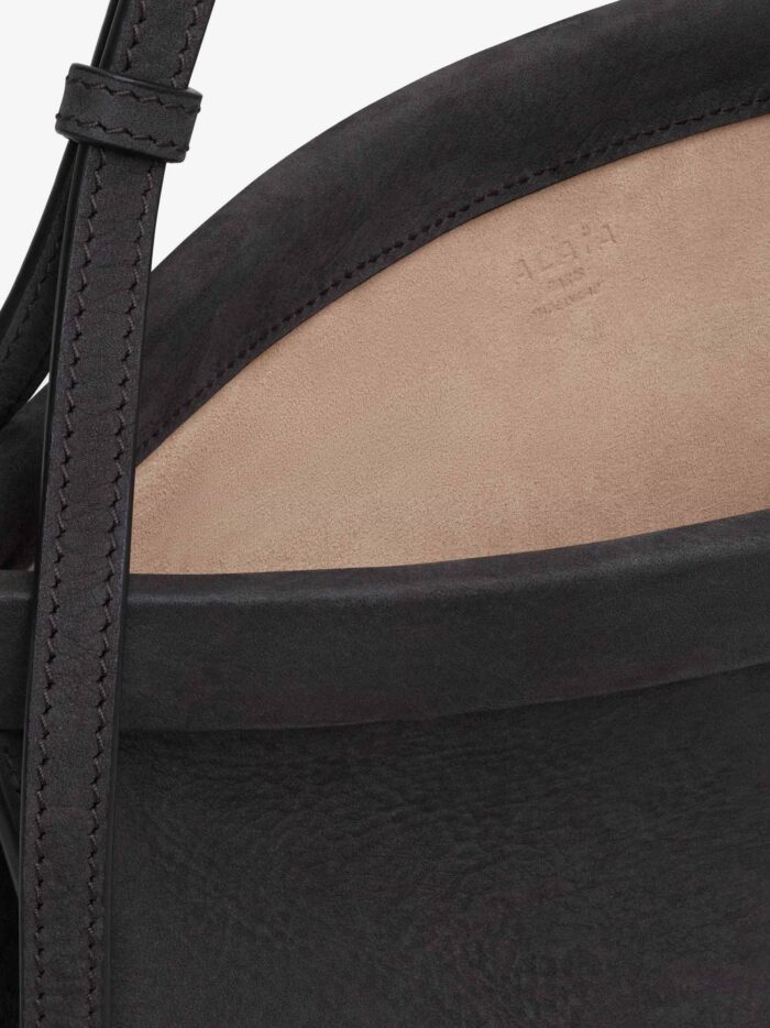 alaia east west leather shoulder bag with engraved lettering logo ALAIA East West Leather Shoulder Bag With Engraved Lettering Logo