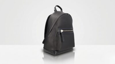 Tom Ford black pebbled leather backpack featuring a structured minimalist design with a silver-tone chunky zipper front pocket for THE WISHLINE luxury men's backpacks collection navigation.
