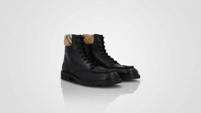 Burberry black leather lace-up combat boots featuring the signature vintage check canvas collar for THE WISHLINE luxury men's boots collection navigation.