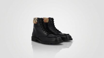 Burberry black leather lace-up combat boots featuring the signature vintage check canvas collar for THE WISHLINE luxury men's boots collection navigation.