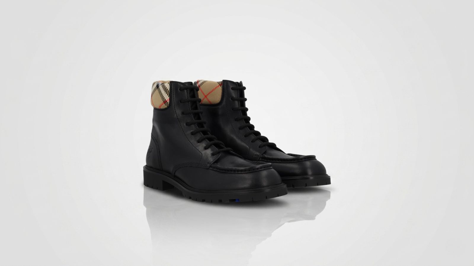 Burberry black leather lace-up combat boots featuring the signature vintage check canvas collar for THE WISHLINE luxury men's boots collection navigation.