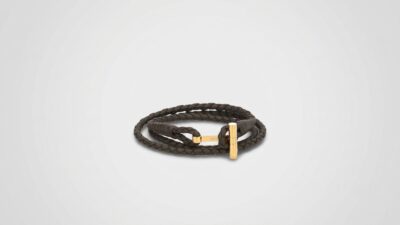 Tom Ford dark brown braided leather wrap bracelet featuring a polished gold-tone T-bar clasp closure for THE WISHLINE luxury men's jewellery collection navigation.