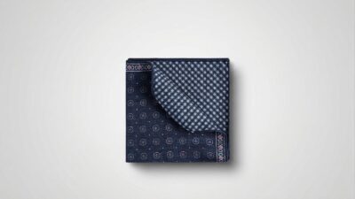 Brunello Cucinelli navy blue silk-blend pocket square featuring a dual-sided design with geometric medallions and a gingham check pattern for THE WISHLINE luxury men's scarves and pocket squares collection navigation.
