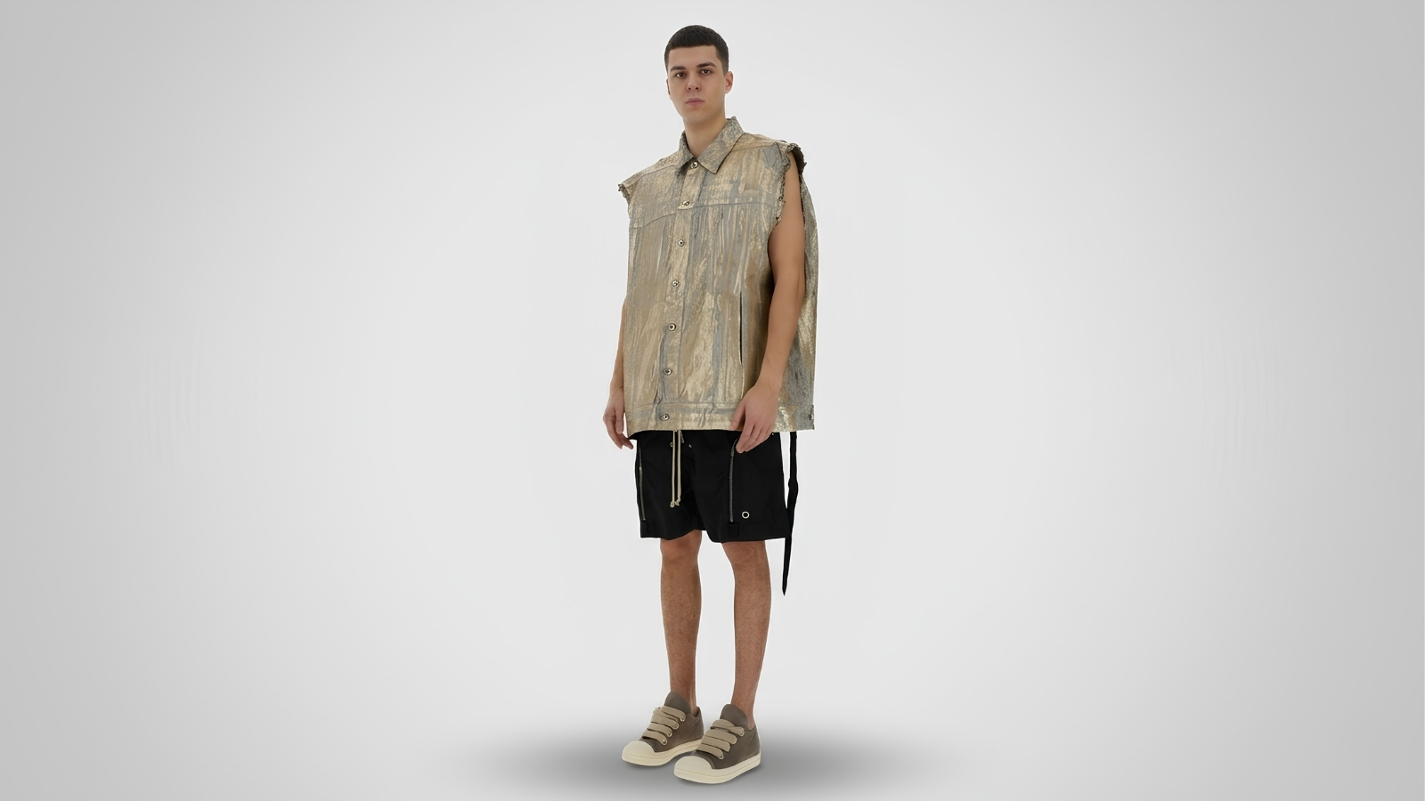 Black drop-crotch drawstring shorts with zipper details, paired with an oversized metallic gold sleeveless button-up shirt and khaki low-top sneakers for THE WISHLINE luxury men's shorts and avant-garde streetwear collection navigation.