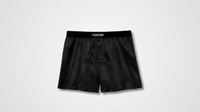 Black luxury silk boxer shorts featuring a wide elastic logo waistband and relaxed fit for THE WISHLINE luxury men's sleepwear, loungewear, and underwear collection navigation.