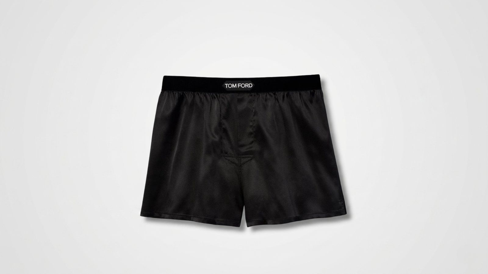 Black luxury silk boxer shorts featuring a wide elastic logo waistband and relaxed fit for THE WISHLINE luxury men's sleepwear, loungewear, and underwear collection navigation.