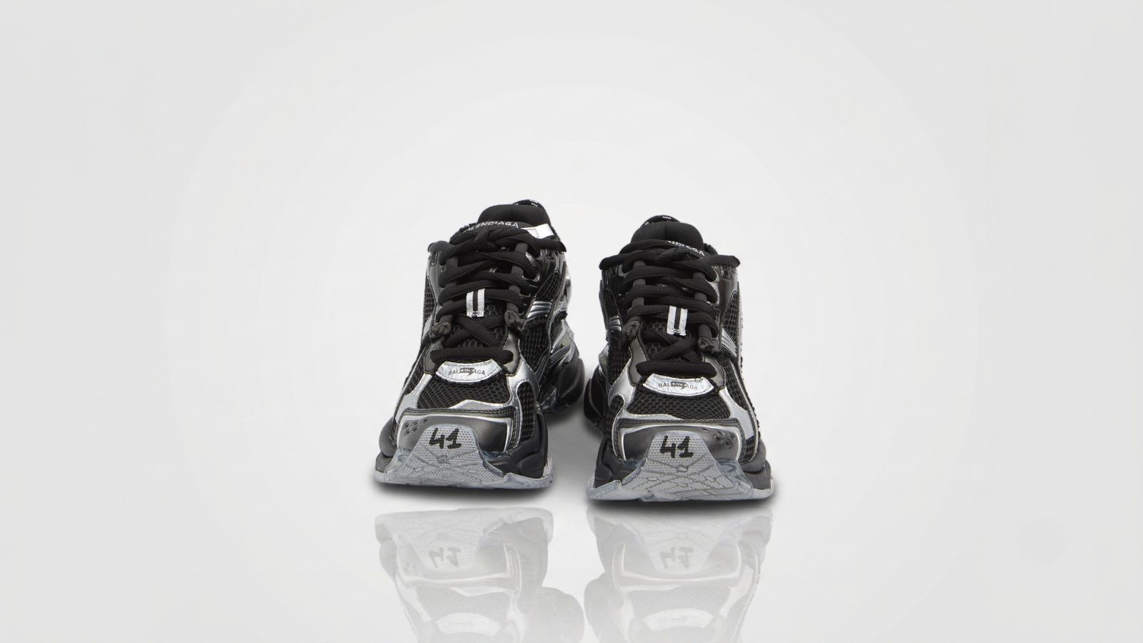 Balenciaga black and metallic silver mesh Runner sneakers featuring the signature size embroidery on the toe cap for THE WISHLINE luxury men's sneakers collection navigation.