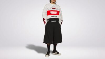 Willy Chavarria x Adidas oversized colorblock sweatshirt featuring bold graphic logos paired with black wide-leg shorts and sneakers for THE WISHLINE luxury men's sweatshirts and hoodies collection navigation.