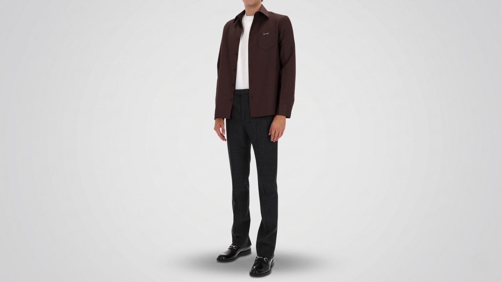 Charcoal grey tailored trousers paired with a dark brown button-up overshirt, a white crewneck t-shirt, and black leather horsebit loafers for THE WISHLINE luxury men's trousers and smart-casual pants collection navigation.