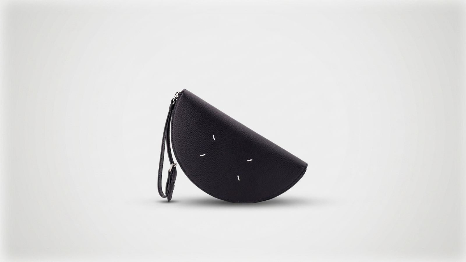Maison Margiela black leather Half-Moon pouch featuring a zip-top closure and signature white four-stitch moniker for THE WISHLINE luxury men's wallets and accessories collection navigation.
