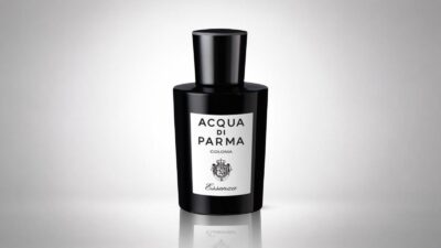 Acqua di Parma Colonia Essenza bottle featuring an opaque black glass design and a minimalist white label for THE WISHLINE luxury cologne for women and men collection navigation.