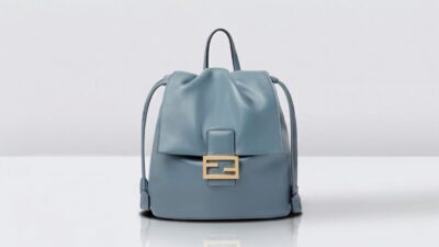Fendi light blue leather drawstring backpack featuring a gold FF baguette buckle detail for THE WISHLINE luxury women's backpack collection navigation.