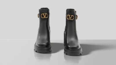 Valentino Garavani black leather ankle boots with gold VLogo buckle details and chunky lug soles for THE WISHLINE luxury women's boots collection navigation.