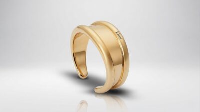 Dior minimal chunky gold cuff bracelet featuring a wide engraved band for THE WISHLINE luxury women's bracelets collection navigation.