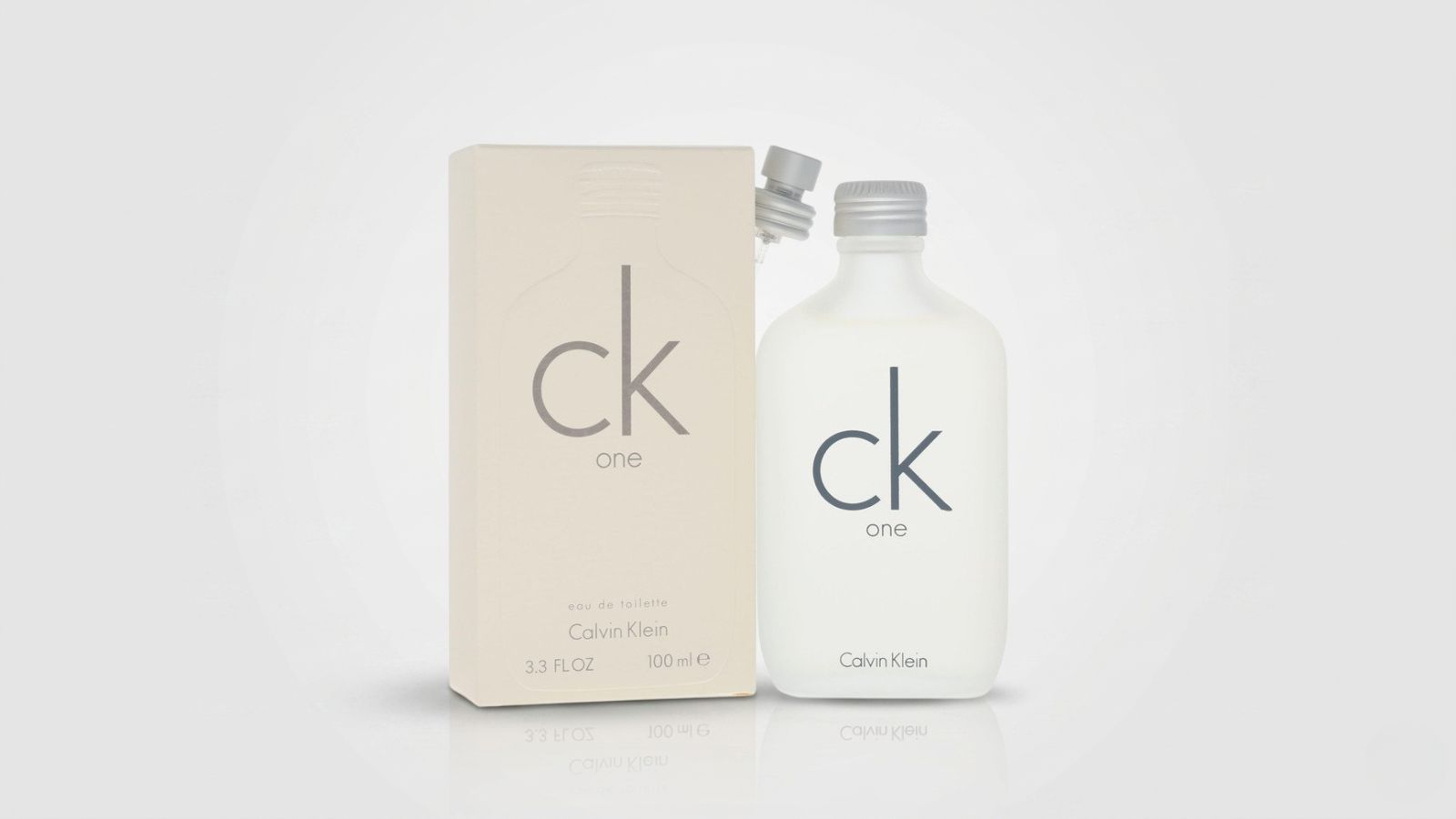Frosted white glass screw-top fragrance bottle standing next to its matching cream-colored packaging box with a separate silver spray pump attachment for THE WISHLINE luxury women's deodorant, body spray, and refreshing mist collection navigation.
