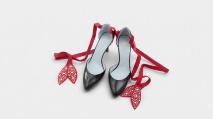 Valentino Garavani black patent leather pointed-toe pump heels with studded red ankle tie ribbons for THE WISHLINE luxury women's shoes navigation.
