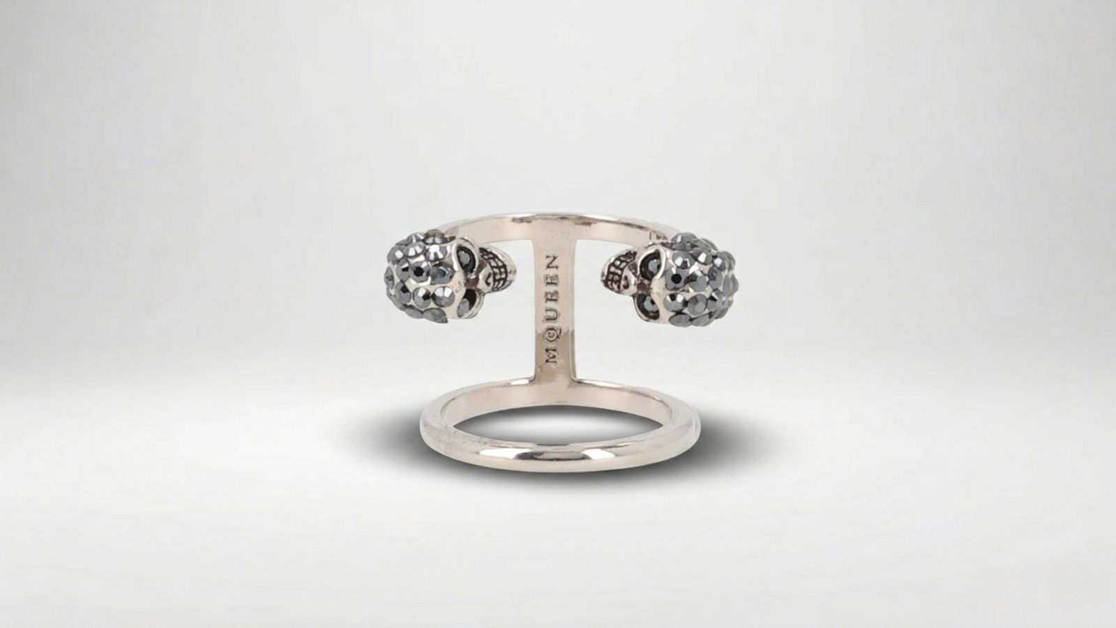 Alexander McQueen silver multi-finger ring featuring an oversized polished metal design for THE WISHLINE luxury women's rings collection navigation.