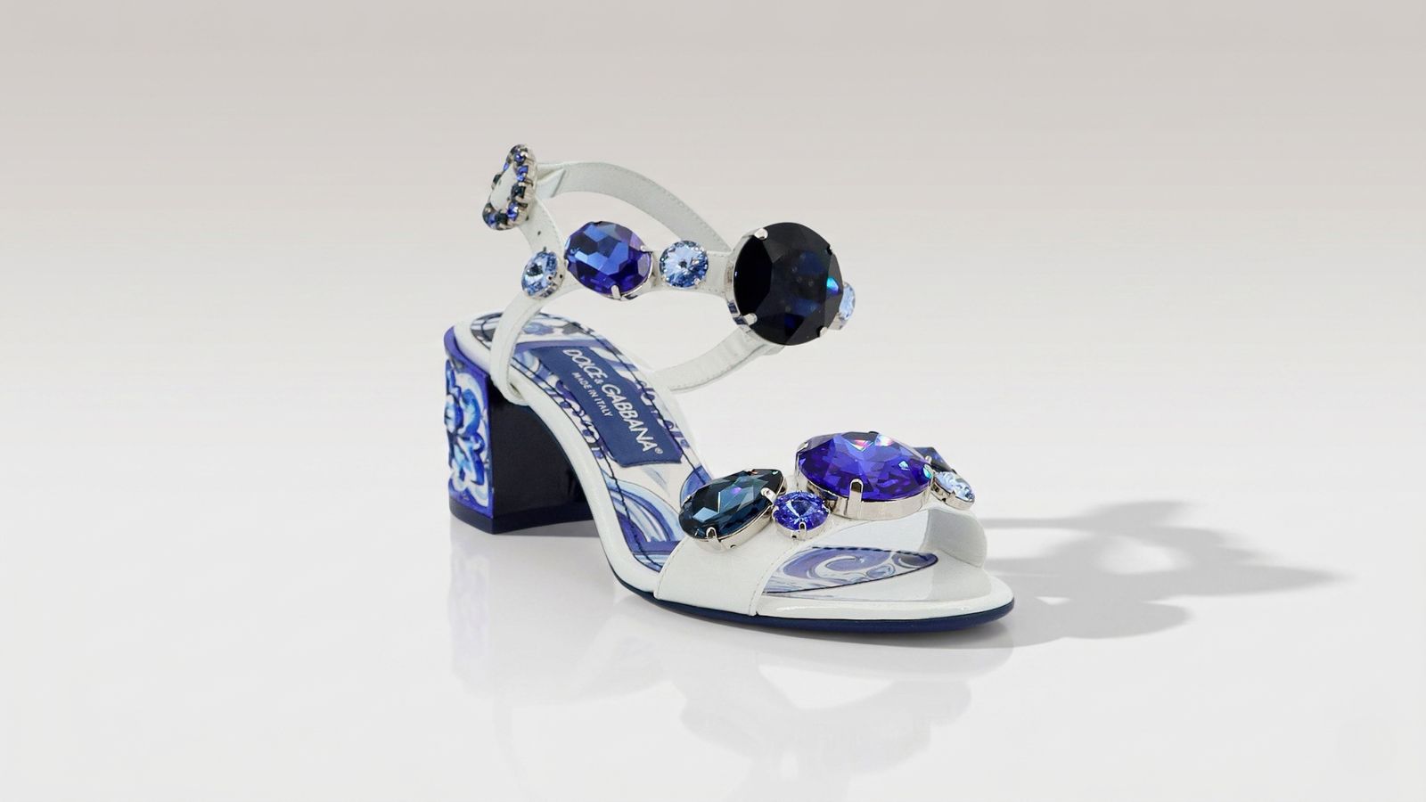 Dolce & Gabbana Majolica print block heel sandals featuring embellished oversized blue crystals for THE WISHLINE luxury women's sandals collection navigation.