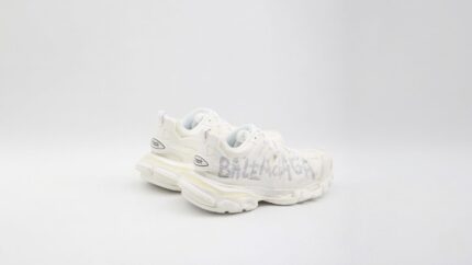 Balenciaga white Track sneakers featuring a distressed finish and hand-drawn style graffiti logo details for THE WISHLINE luxury women's sneakers collection navigation.
