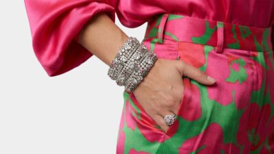 Close-up of diamond encrusted luxury statement bracelets and a matching floral cocktail ring for THE WISHLINE fine jewellery navigation.