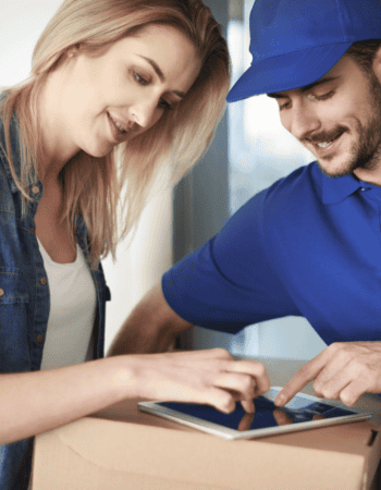 Delivery person assisting a customer with a package.