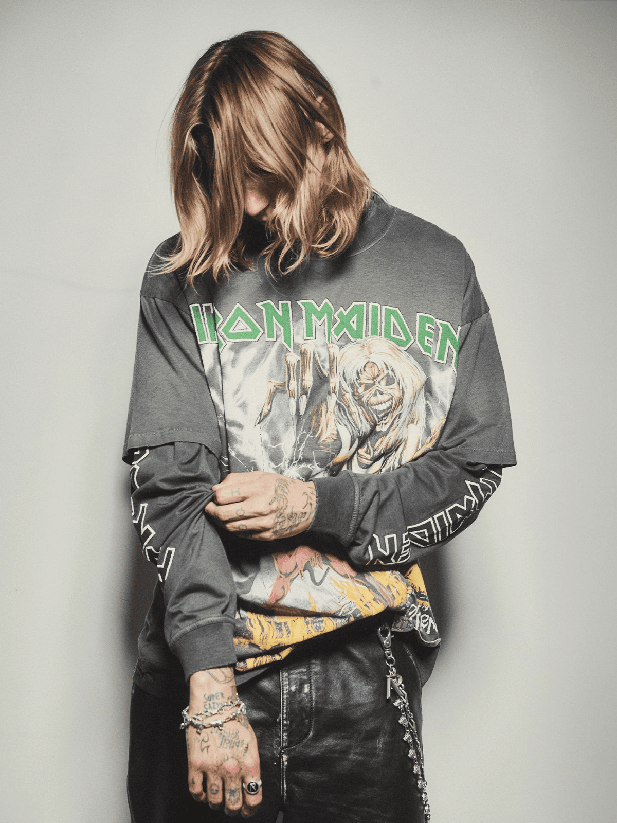 Men’s Luxury Boutique – Model wearing Iron Maiden graphic sweatshirt and leather pants.