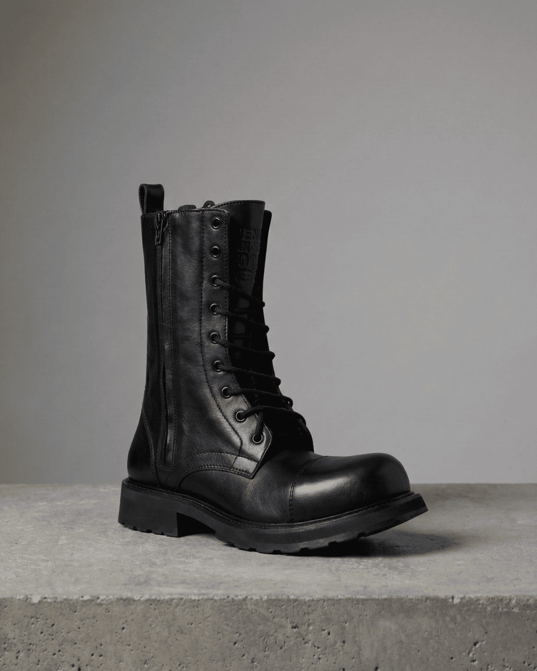 Men’s black leather lace-up boots on display – seasonal offers on designer footwear.
