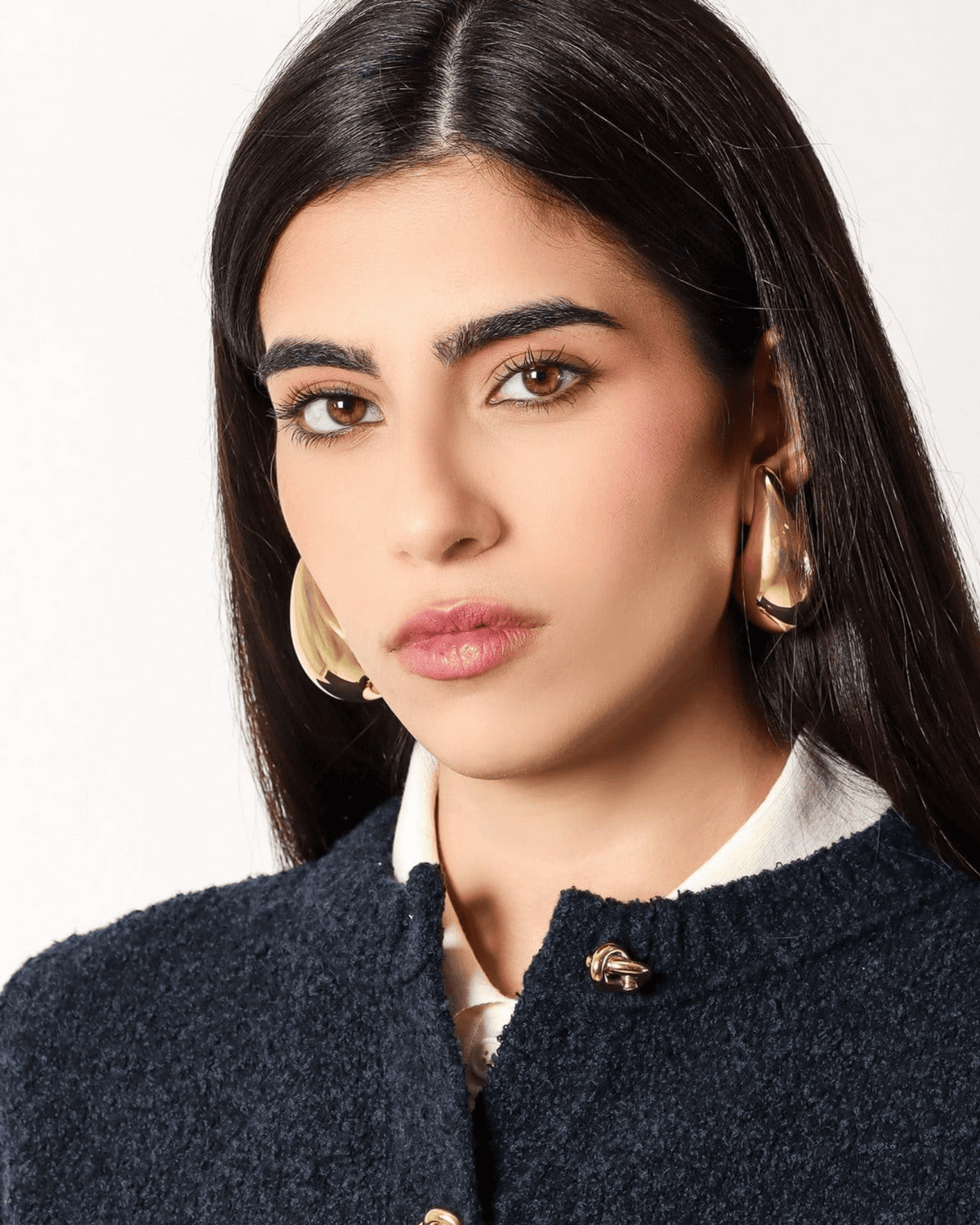 Model wearing sculptural gold hoop earrings from THE WISHLINE Women’s Jewellery Collection — part of the Seasonal Offers edit.