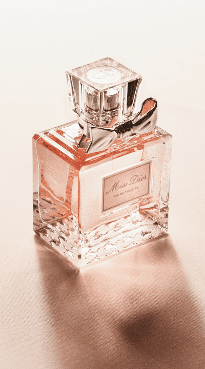 Miss Dior Eau de Toilette bottle on soft satin surface – luxury women's fragrance with feminine allure.