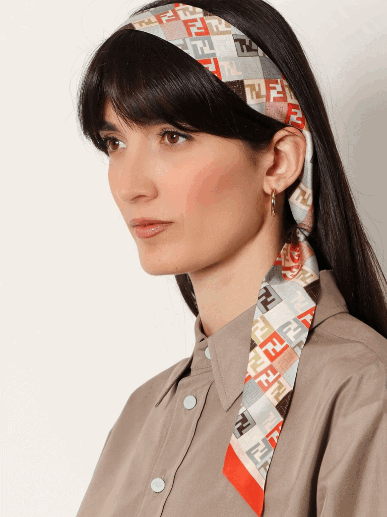 Woman wearing a multicolor printed silk scarf as a headband with a taupe button-down shirt – scarves category banner on THE WISHLINE.
